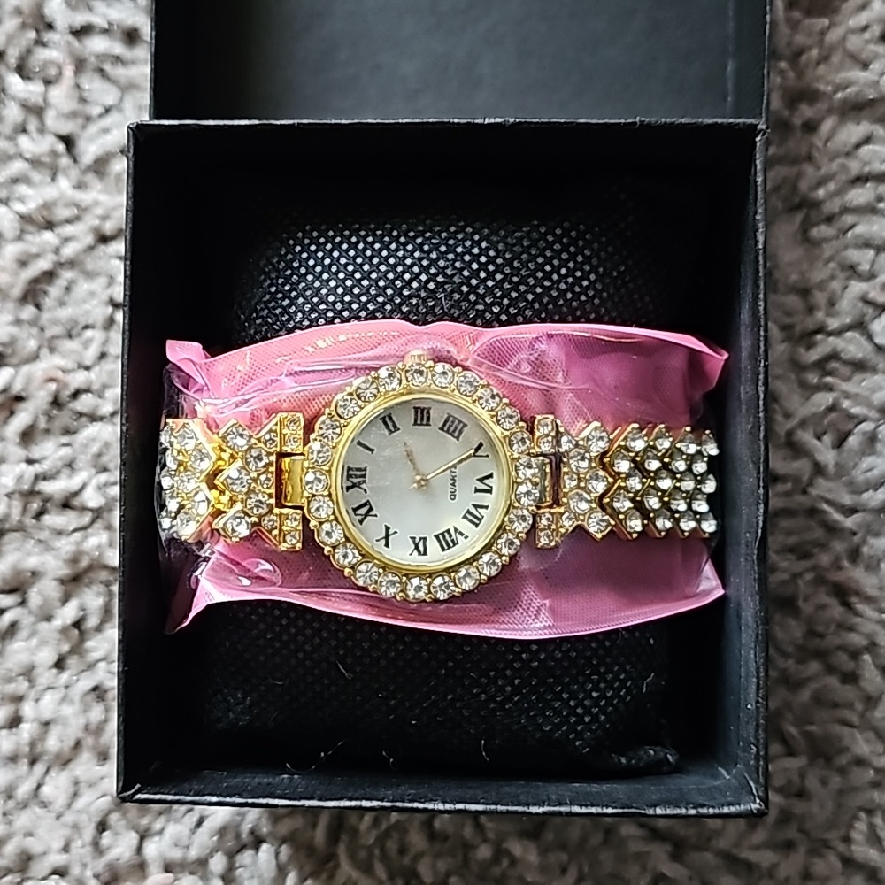 Gold embellished watch with Roman numerals with box